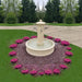 Avignon Outdoor Fountain in action on gravel pad surrounded by pink flowers