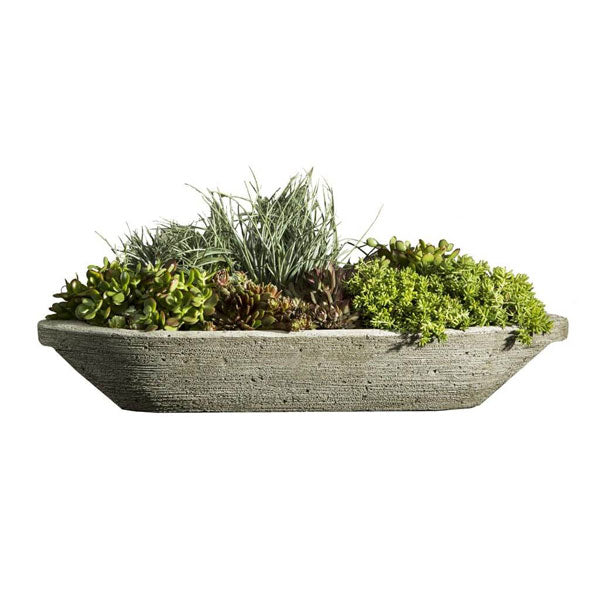 Barca Planter filled with plants against white background.