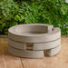 Guard Riser Round on table against green leaves.