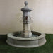 Octavia Column Only Plumbed for pond on grass against white wall.