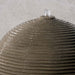 Ribbed Sphere Fountain on concrete in the backyard upclose