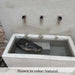 X3 Fountain in action on pebbles upclose.